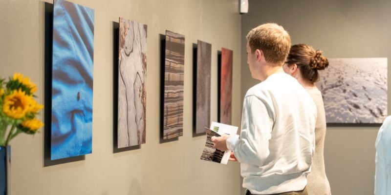 Opening night guests look at Ryan's photography. 