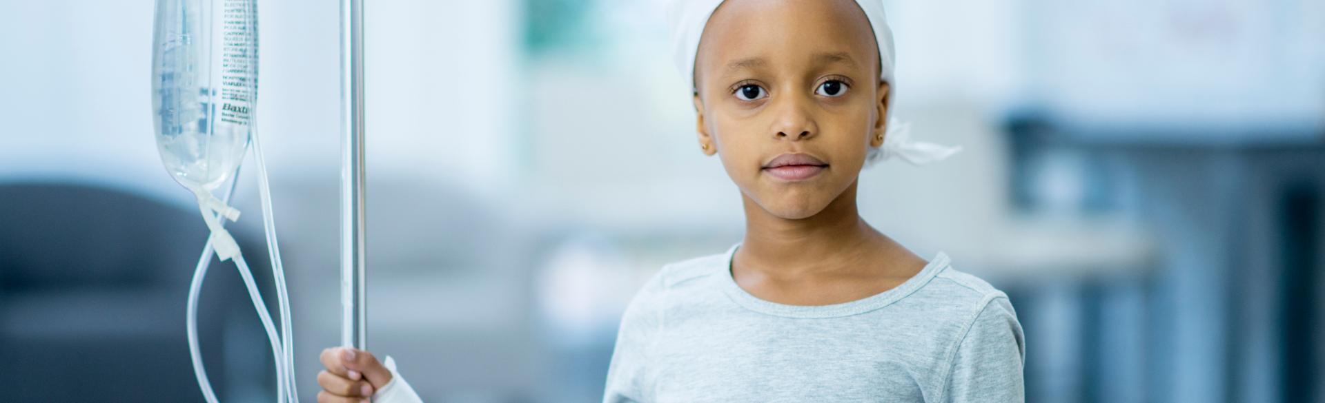 Young Black girl in hospital gown