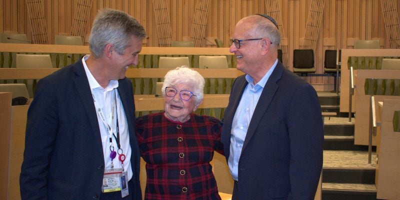 Center Director Matt Wynia, MD with Helen Morris, MD and Bruce Feldstein, MD smiling in the Gossard Forum