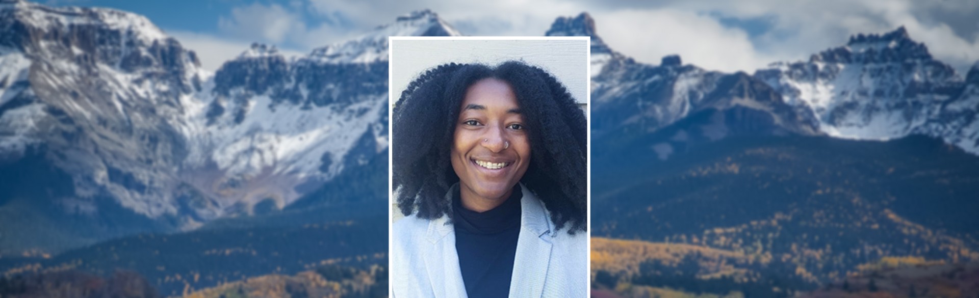 Raeven Clockston headshot, mountains in background