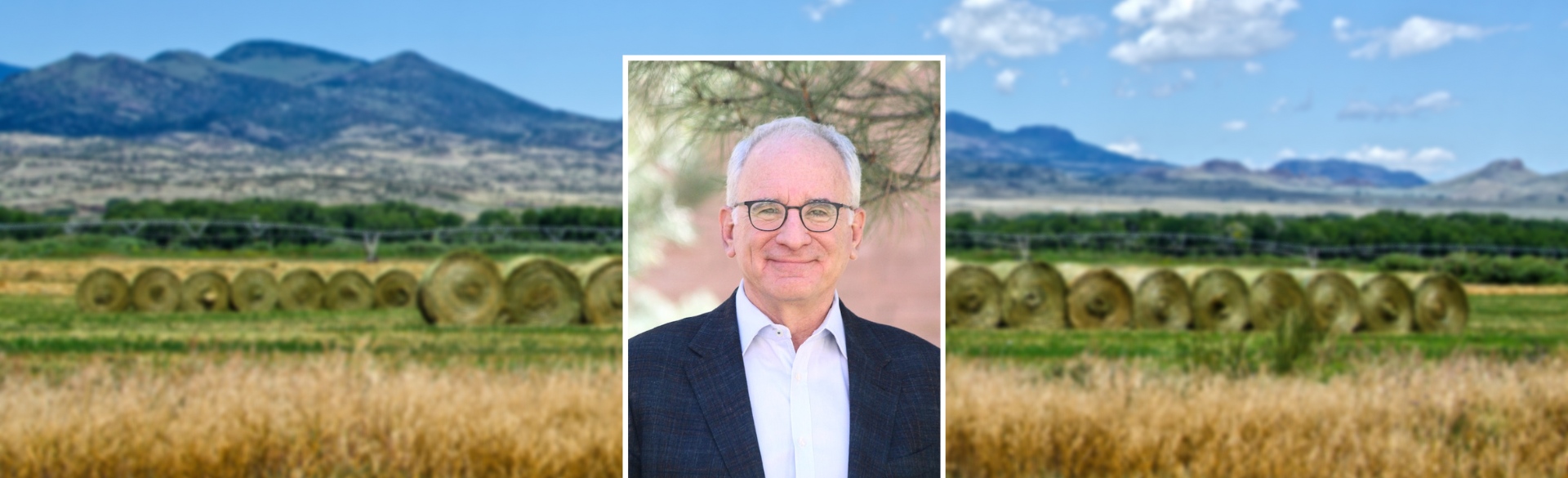 Man smiling in headshot on background of Colorado mountains