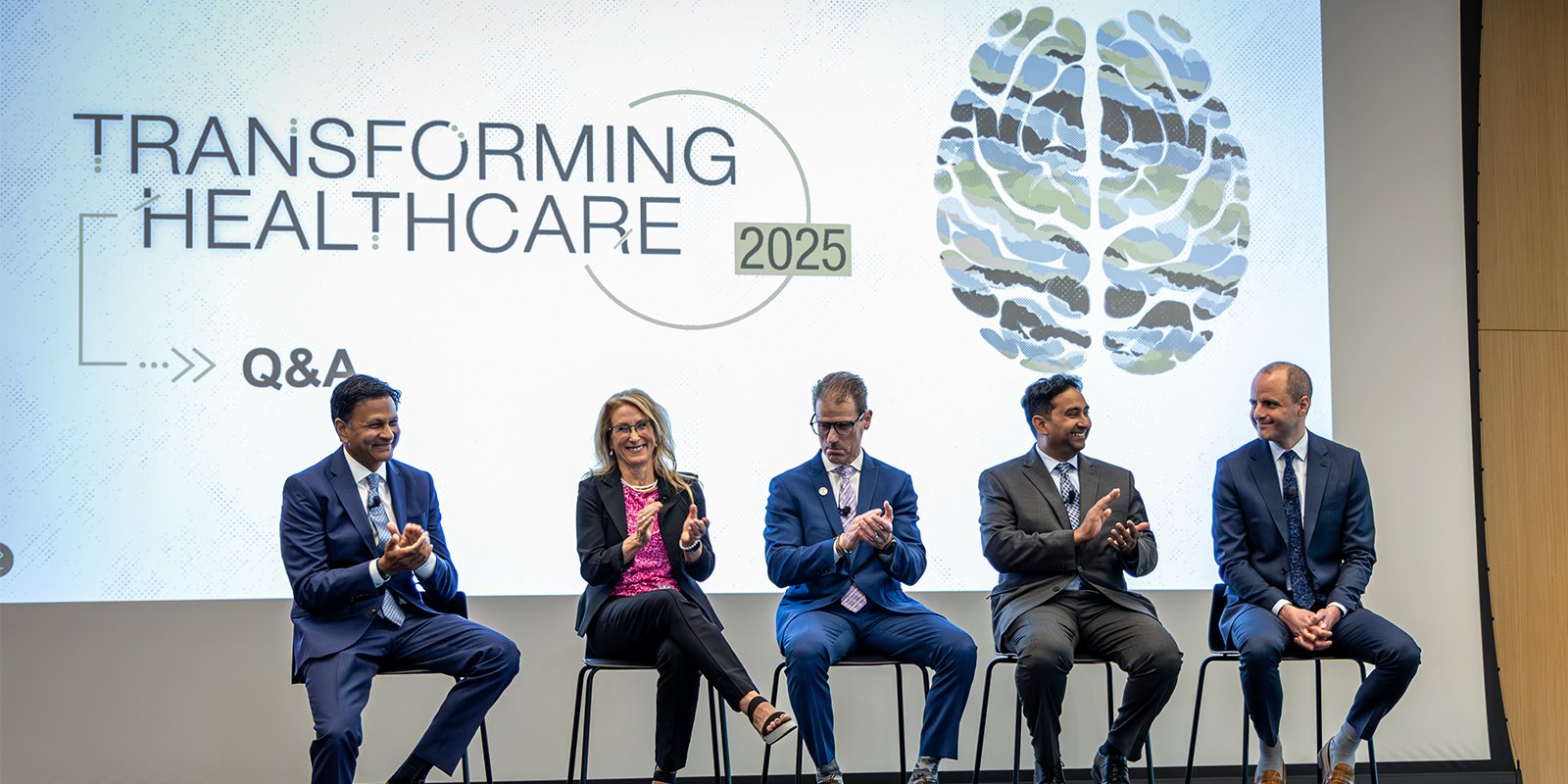 The panel from Transforming Healthcare panel on Military Medicine and the Mind sits on stage at CU Anschutz.