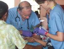 Dr. Asturias and Mehner treating a child a the clinic