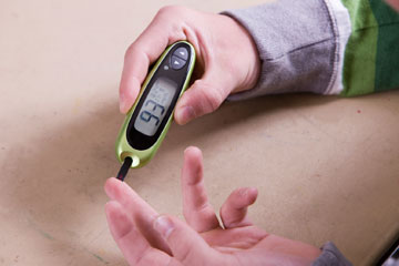 Blood sugar test on child's finger
