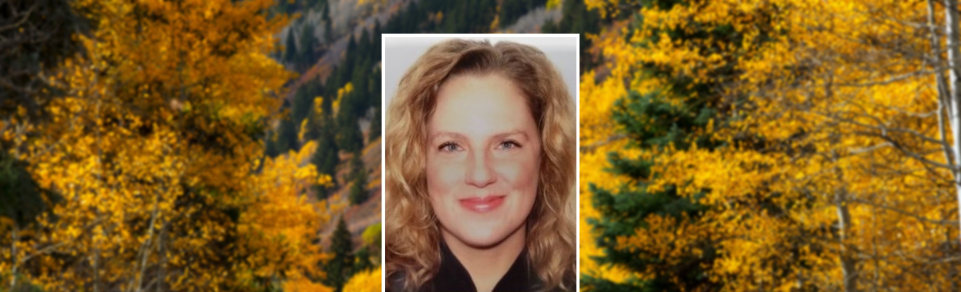 Alisa Koval headshot on background of Colorado trees