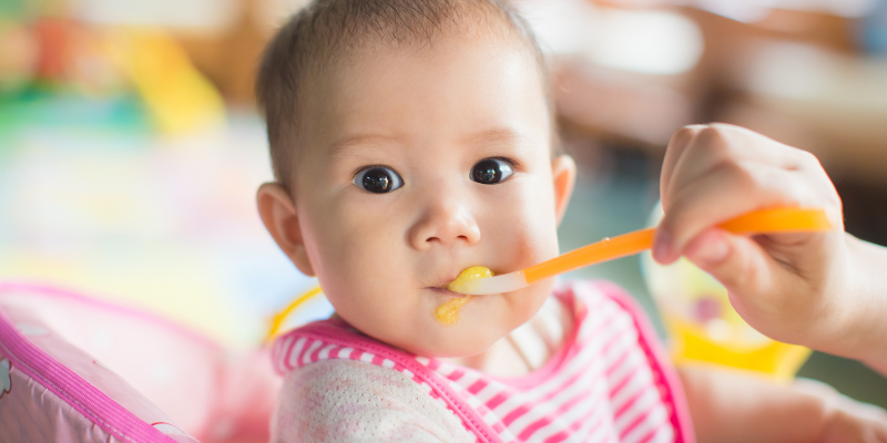 Baby being spoon fed