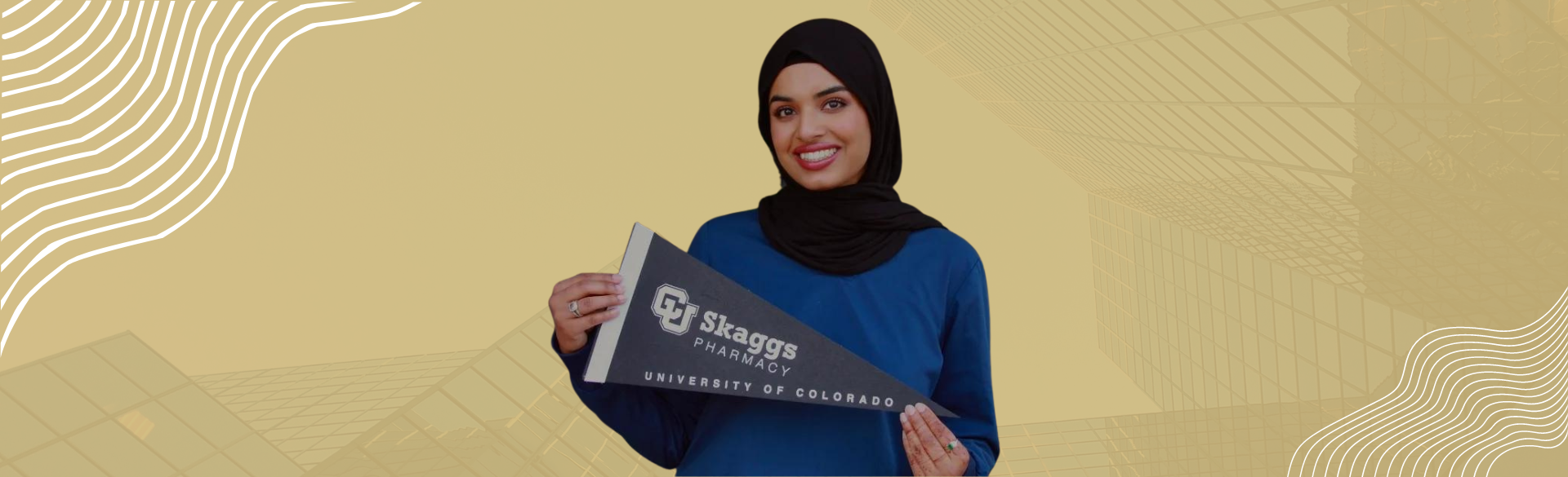 Incoming CU Pharmacy student smiles with a CU Pharmacy pennant 