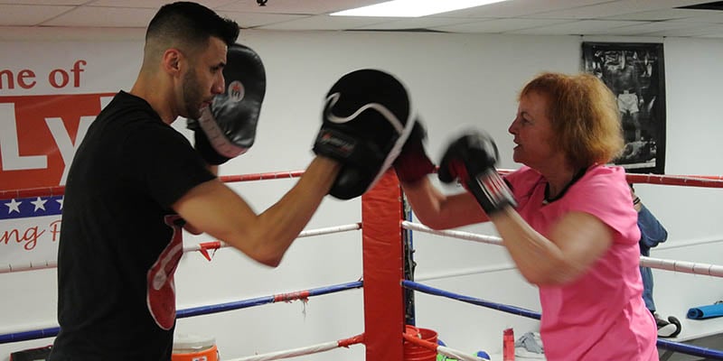 Woman boxes as part of the Power Punch Parkinson's program.