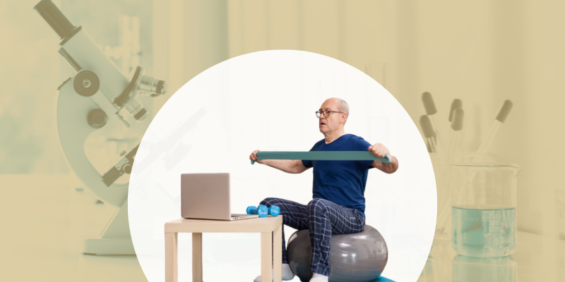 Man exercising at home with a laptop in front of him 