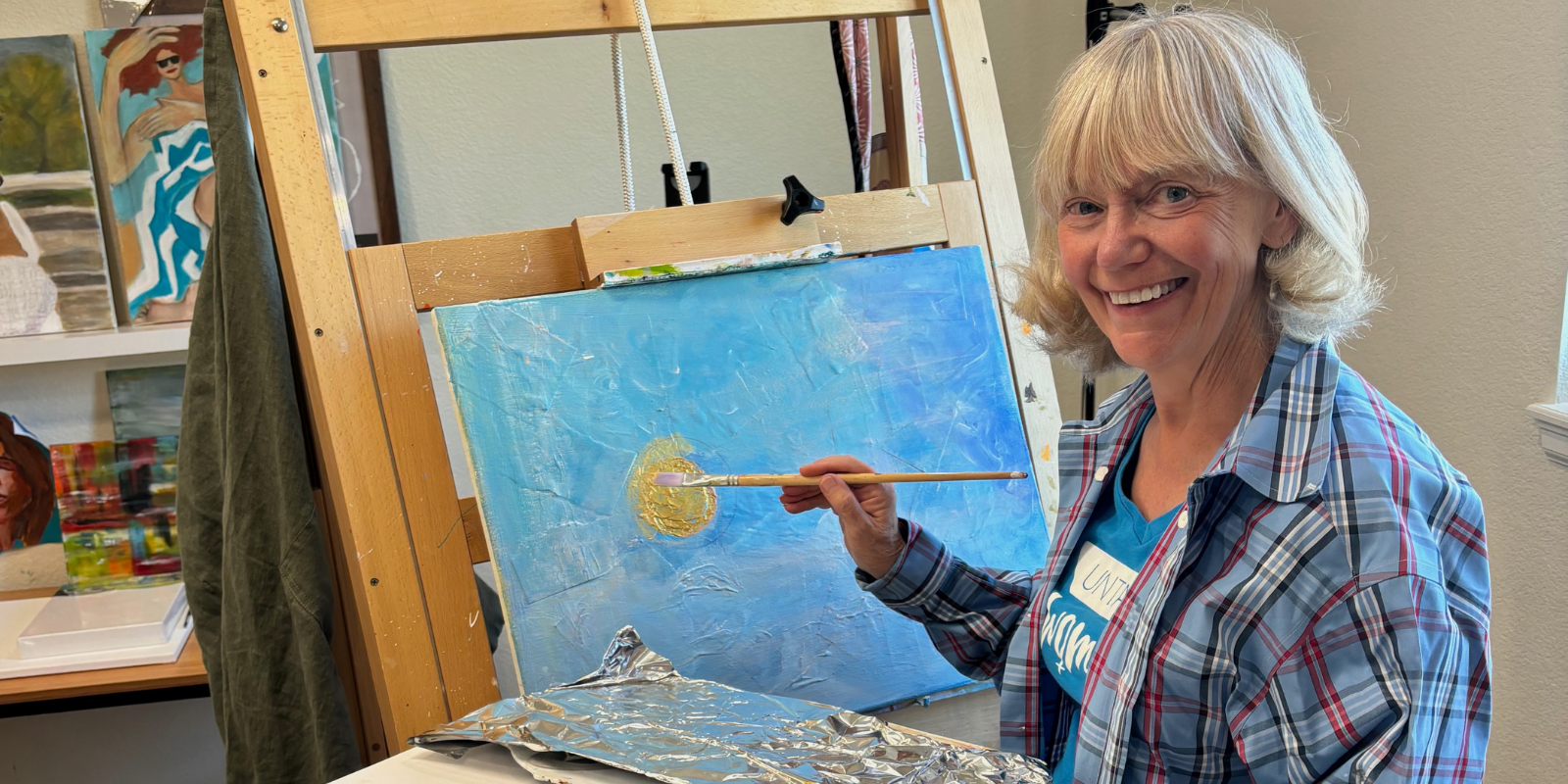 Rebecca Chopp painting a picture.