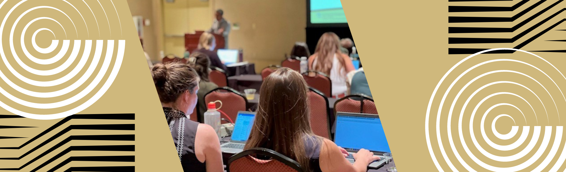 Design and image of people in a large conference room, listening to a presentation.