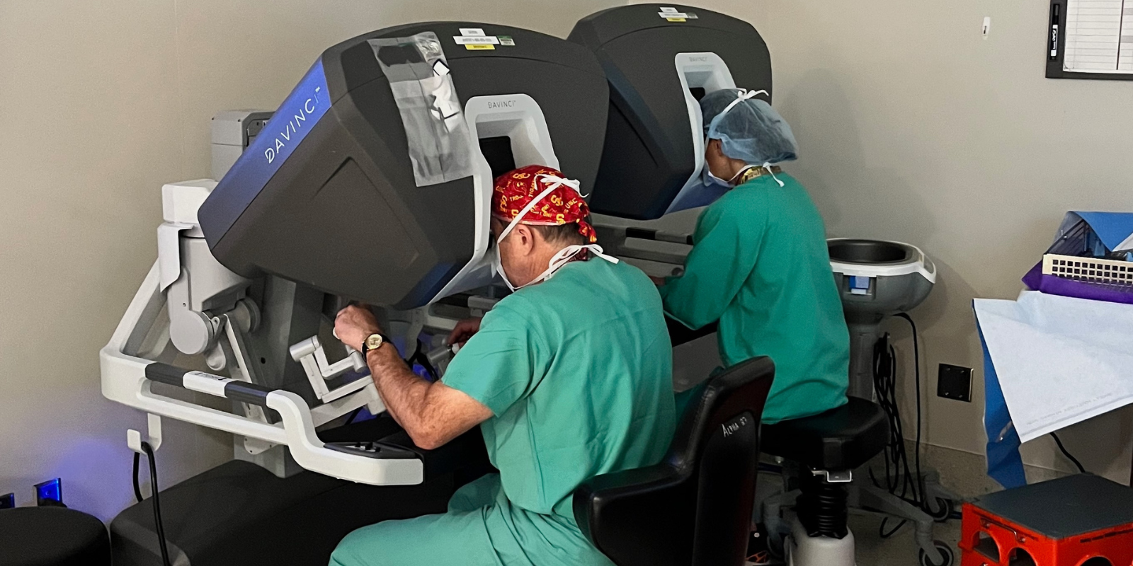 Cardiothoracic surgeons Joseph Cleveland, MD, and Jessica Rove, MD, at the controls of the DaVinci surgical robot.