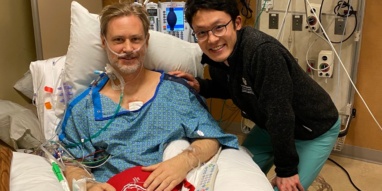 Cardiothoracic ICU patient Tony Hillerson, awake after surgery, with SOAR program founder Mikita Fujita, MD.