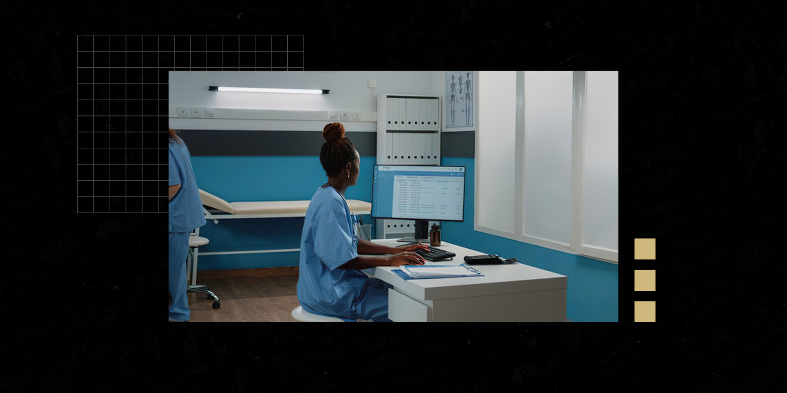 Photo of a clinician sitting at a computer in a health care setting.