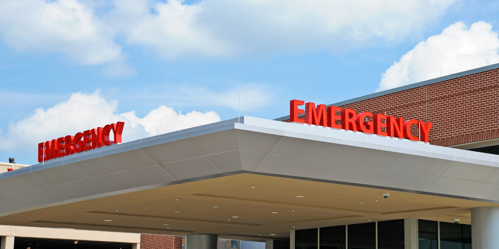 The word "emergency" is shown as a sign in big letters across the top of a medical center