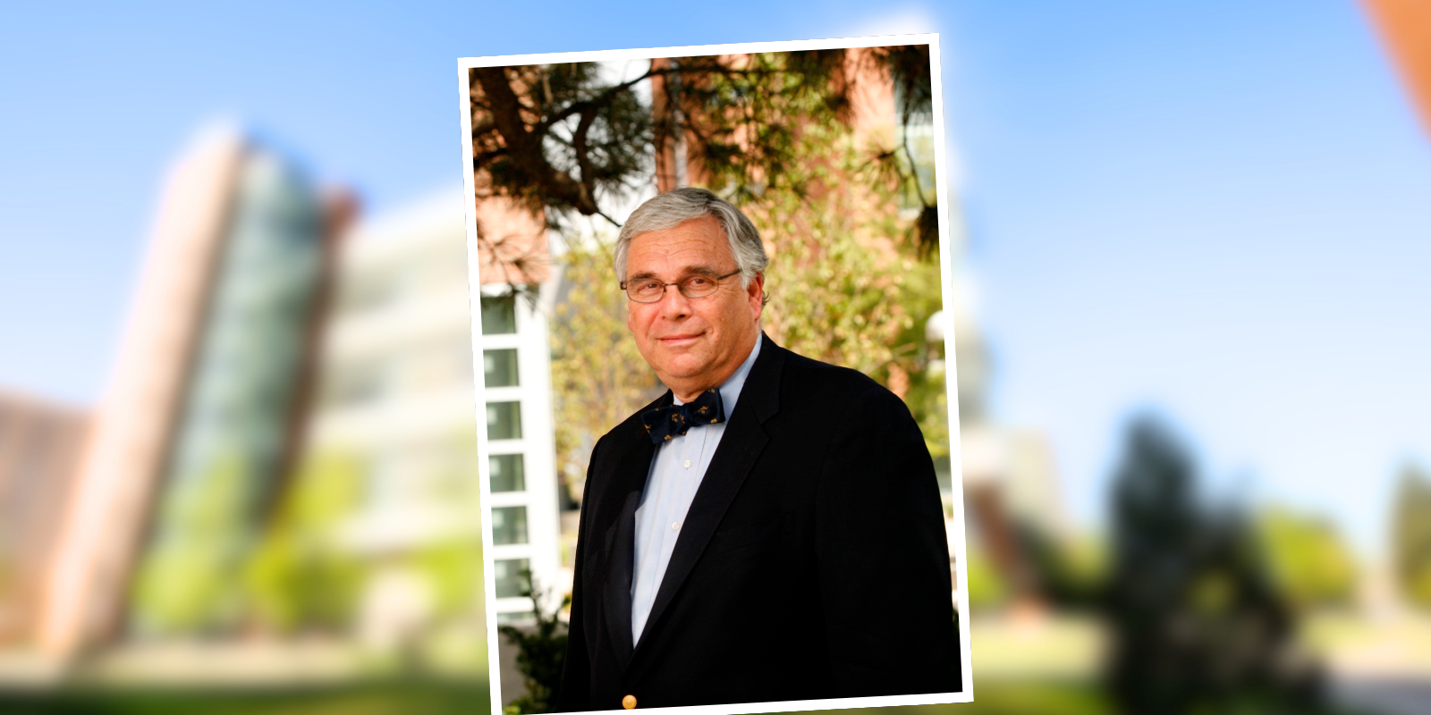 Portrait of Richard Krugman, MD, against blurred backdrop of the CU Anschutz campus.