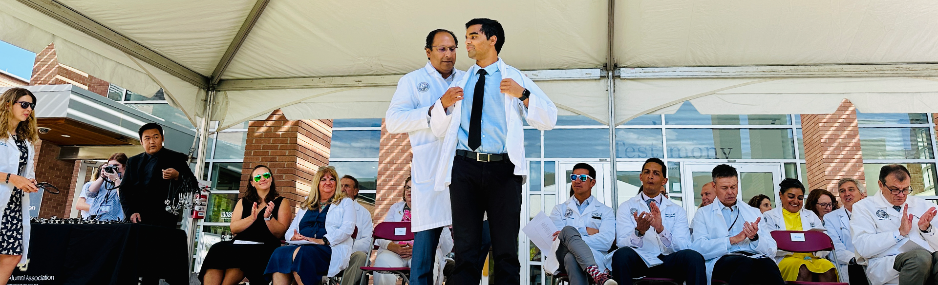 A member of the Class of 2027 receives their white coat