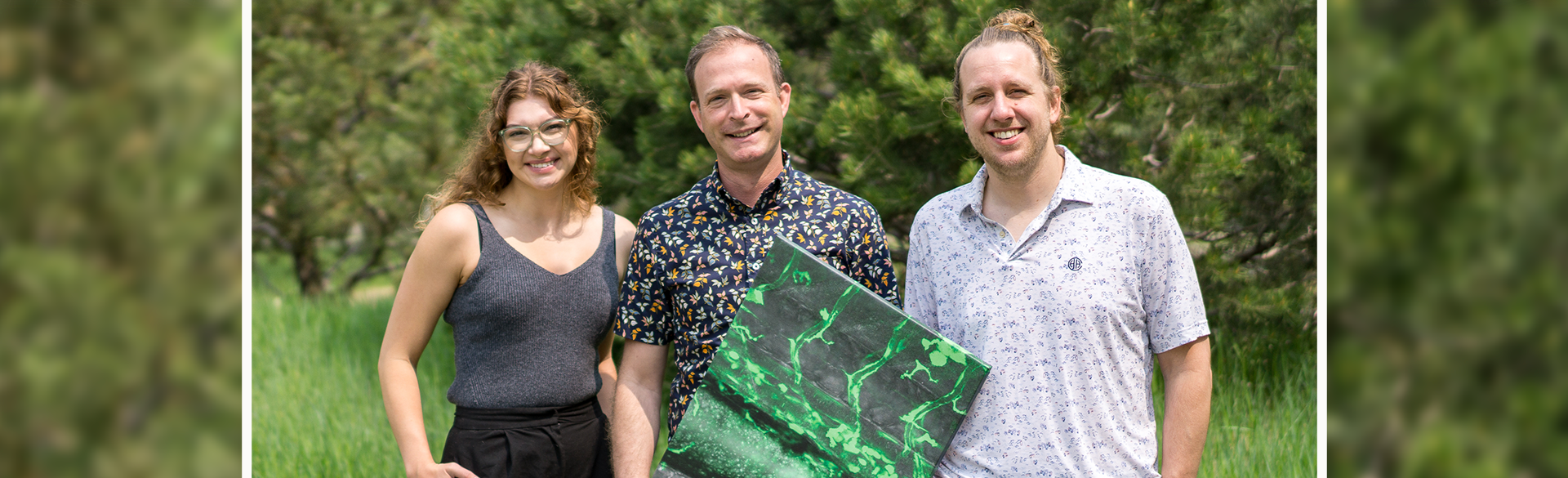 Hannah Moran, Christian Mosimann, PhD, and Robert Lalonde, PhD, with a microscopy panel of labeled cells.