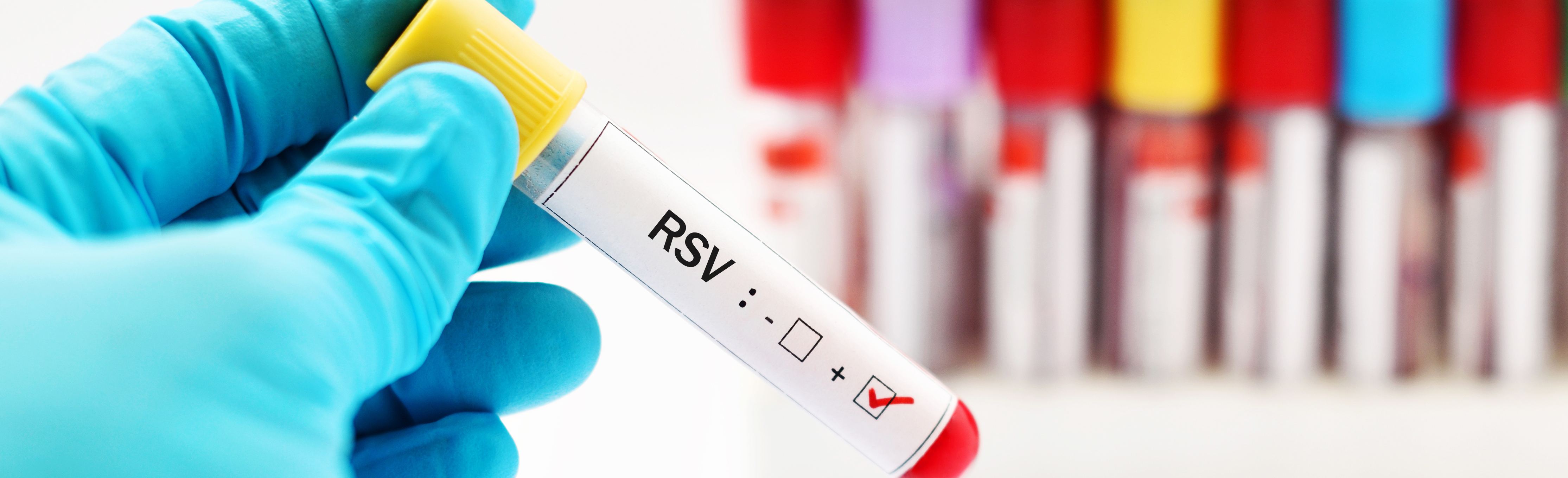 Gloved hand holding sample vial labeled "RSV"