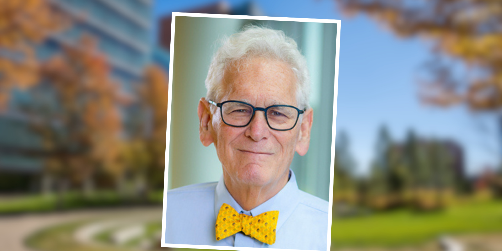 Portrait of Steve Berman in a yellow tie and button up shirt.