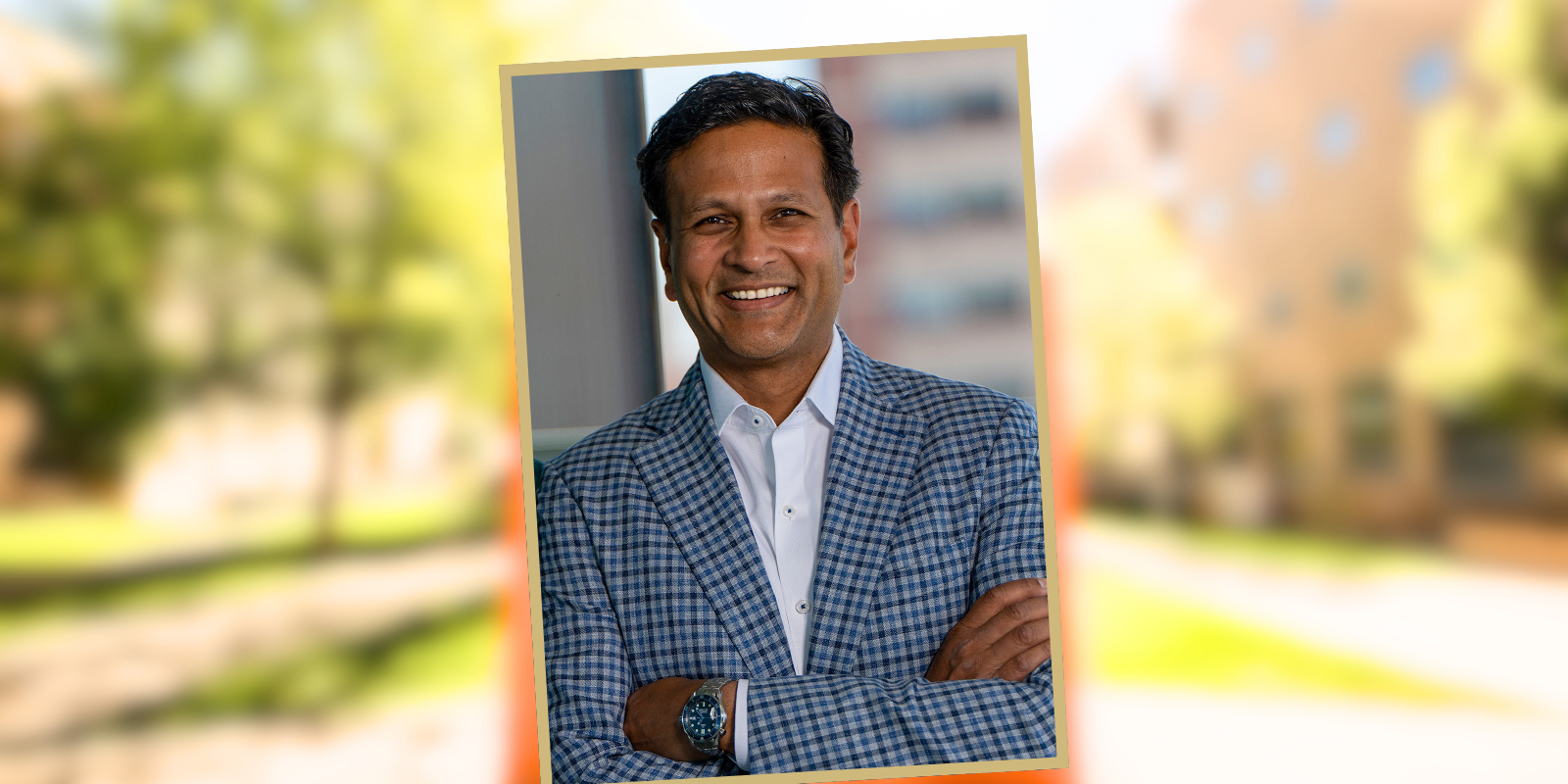 Portrait of Vik Bebarta, MD, against a blurred backdrop of the CU Anschutz campus.