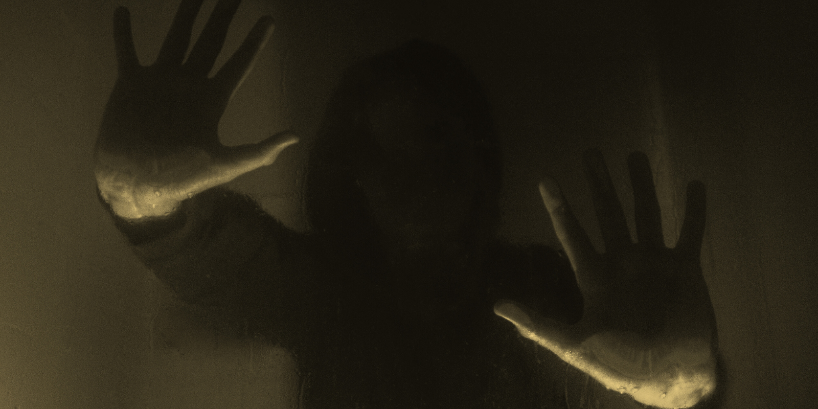 An image of a dark shadowy figure reaching out. 