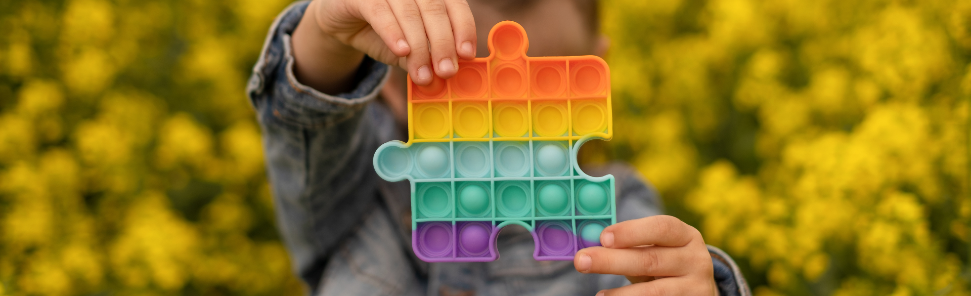 Child holding multicolored puzzle