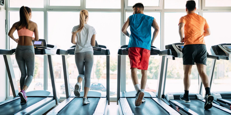 people running on treadmills at the gym