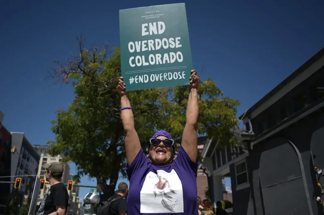 Woman holding a sign that says 