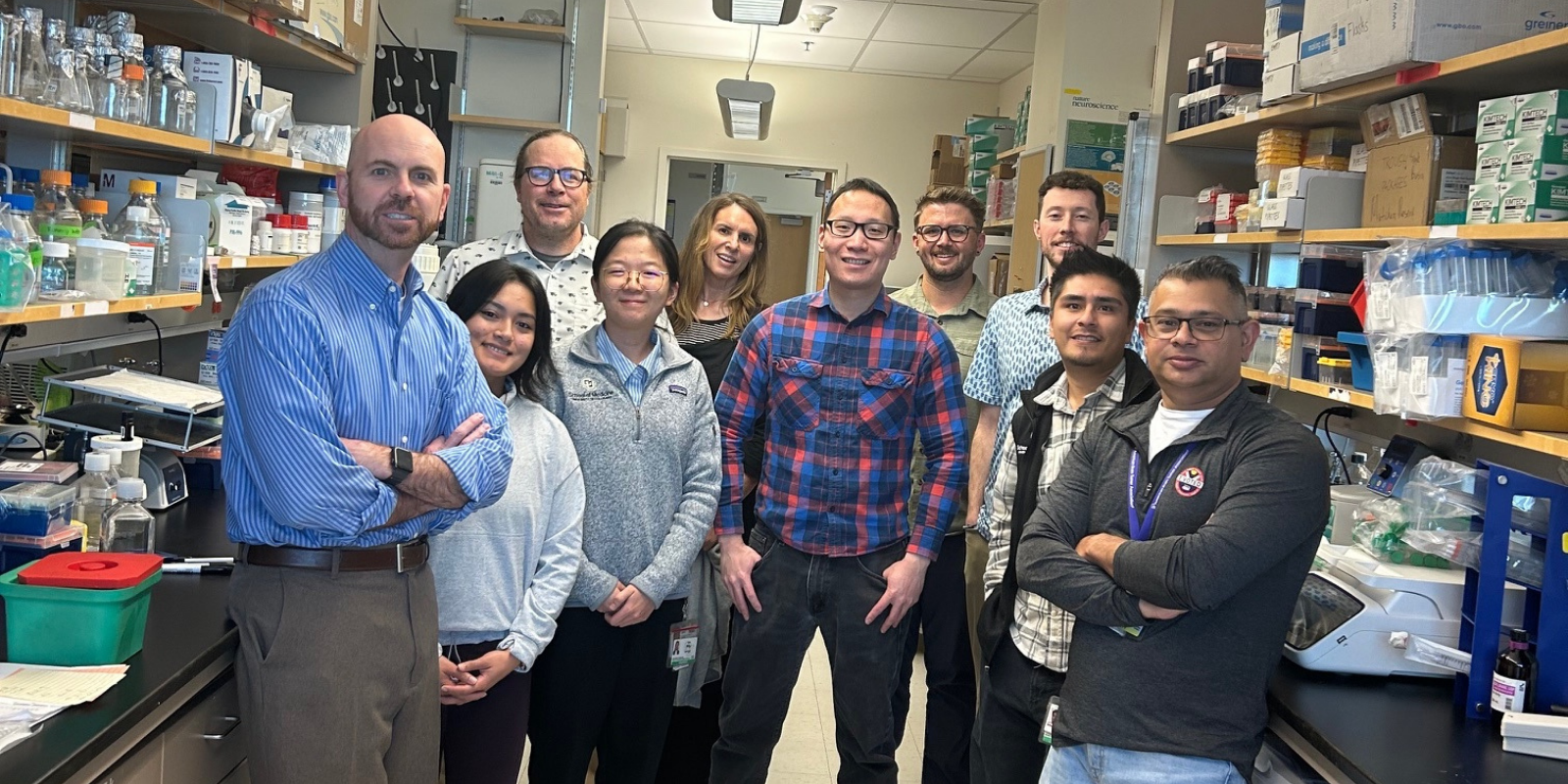Todd Hankinson, MD, far left, and Siddhartha Mitra, PhD, far right, with members of their lab. 