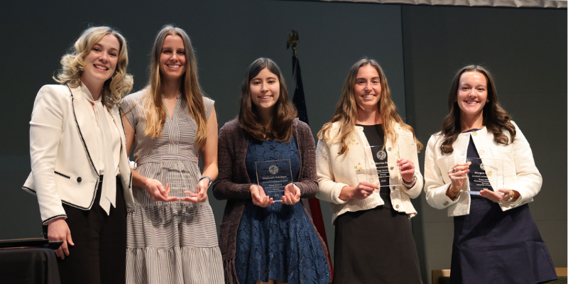 Pharmacy students receive awards on stage.
