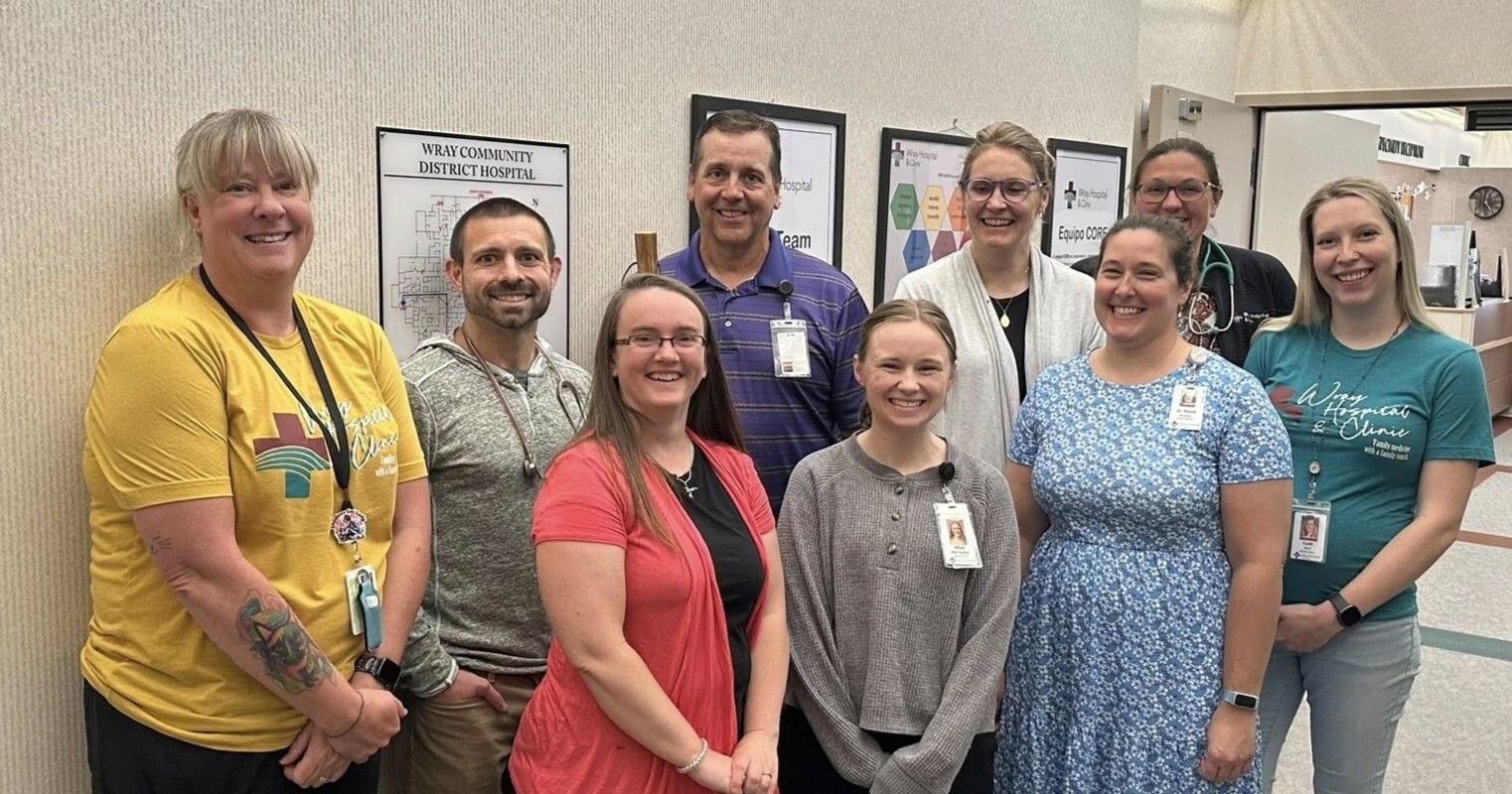 Dr. Reed posing with students and Wray clinic staff