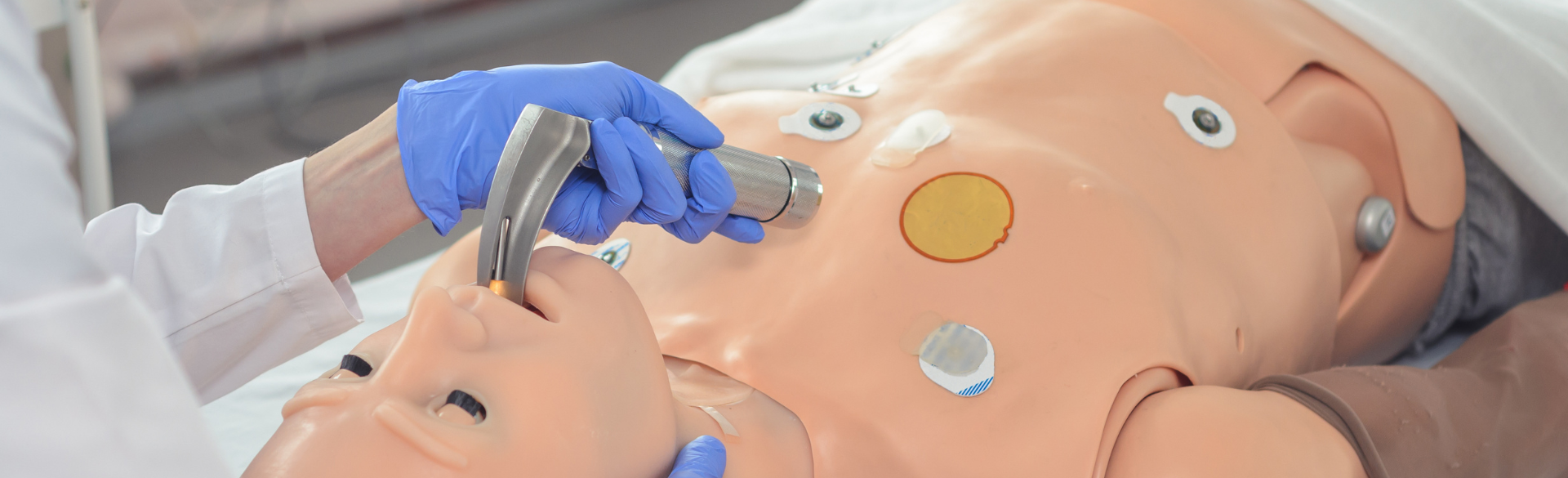 Physician performs intubation on mannequin