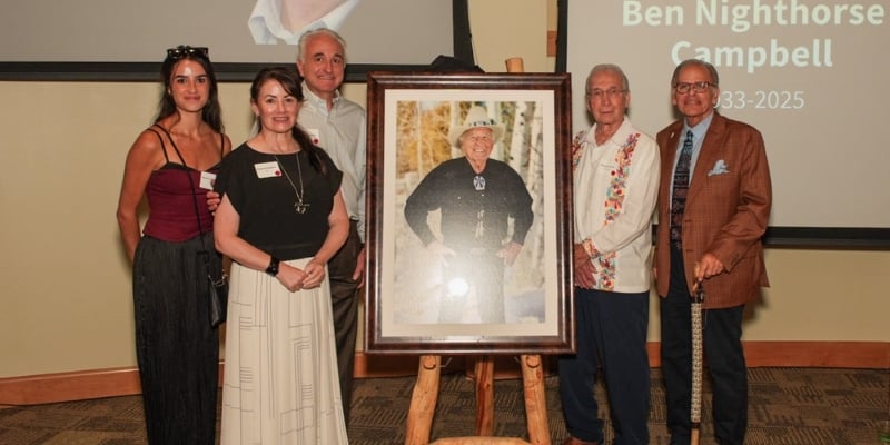 a family stands around a portrait of senator ben nighthorse campbell