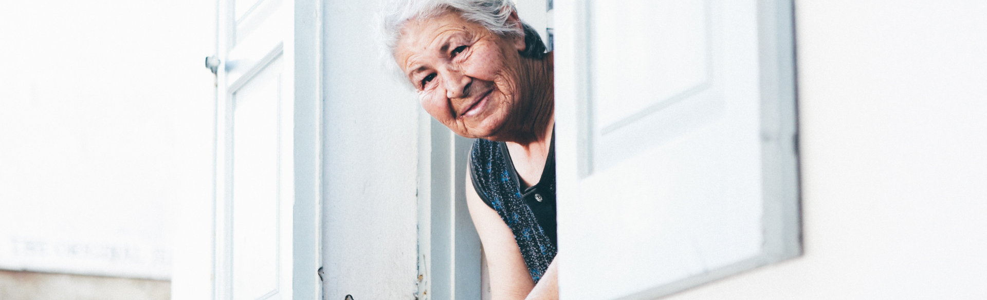 Woman leaning out window smiling