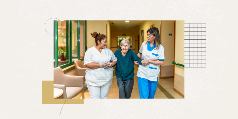 Elderly patient in hospital walking, supported by two nurses