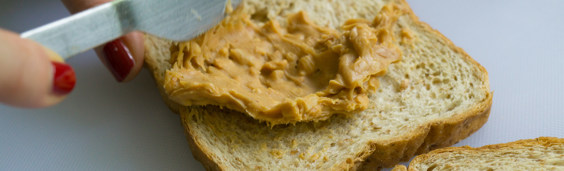 peanut butter is spread on a slice of bread