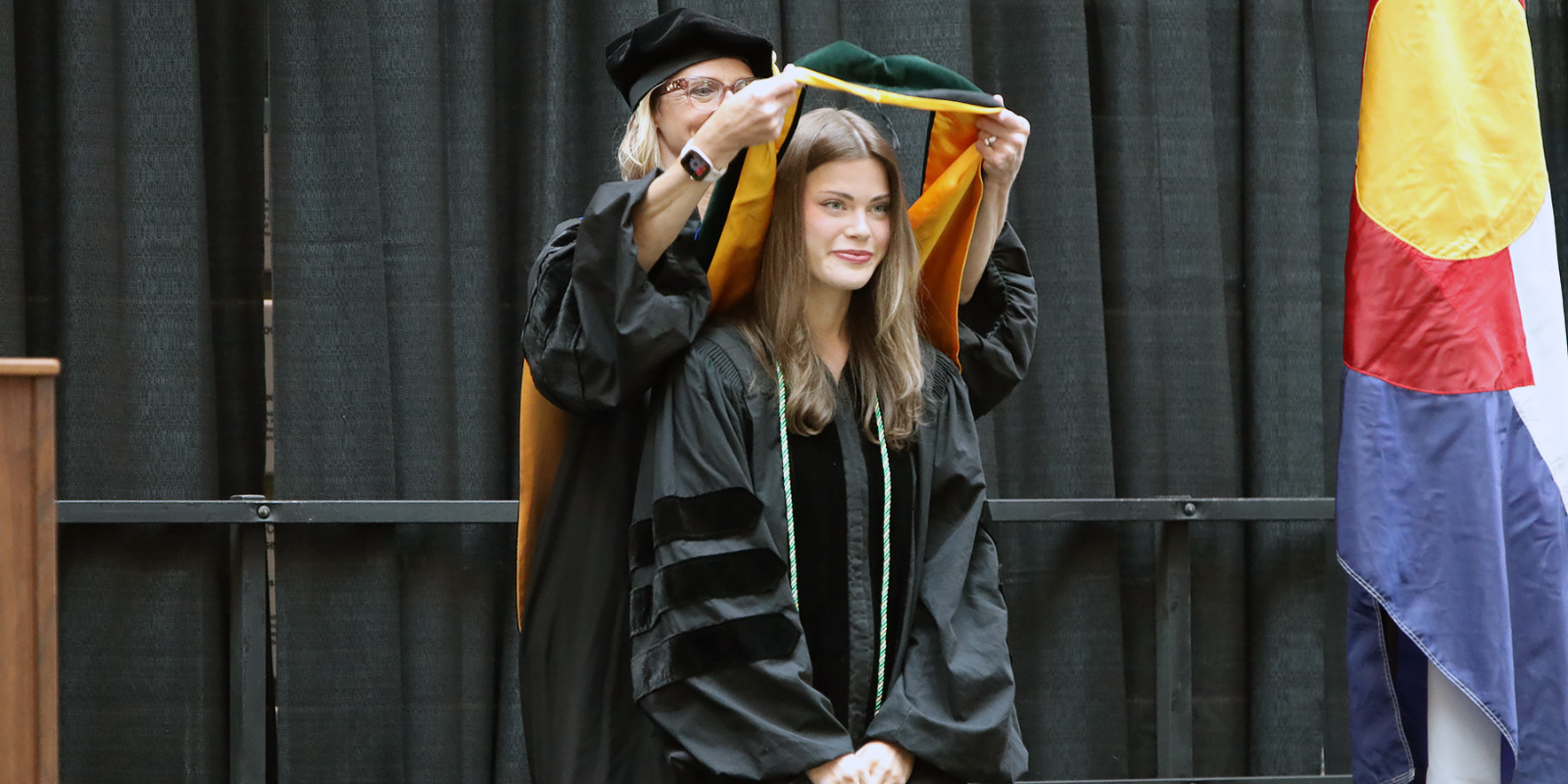 A CU Anschutz School of Medicine graduate being hooded as part of the ceremony on May 18.